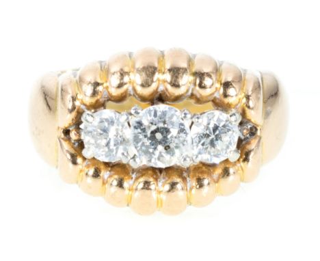 A diamond three stone ring, the old brilliant cut stones claw set in white metal to the centre of a yellow metal mount with f