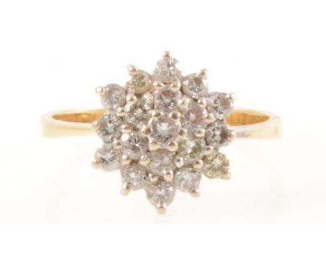 A diamond cluster ring, nineteen brilliant cut diamonds claw set in an 18 carat yellow and white gold circular cluster mount 