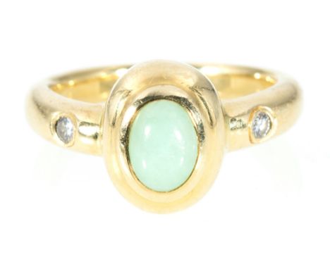 A jade and diamond dress ring, the oval cabochon cut jade, 6.5mm x 5mm, collet set in 18 carat yellow gold on a 3mm wide D sh