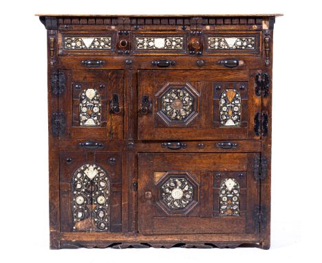 A joined oak cabinet, 17th Century and later, stained wood top over a dentil frieze, fitted with a single long drawer over fo