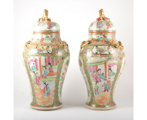 Pair of Cantonese covered vases, probably early 20th century, of baluster shaped with domed lids and temple lion finials, the