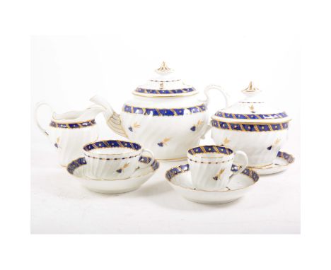 A porcelain part tea service, by Worcester, Flight period, wrythen moulded with dispersed sprigs and banding in blue and gilt