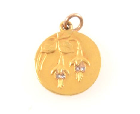 A yellow metal circular flower pendant, fuchsia design to front with four small rose cut diamonds, engraved name and date to 