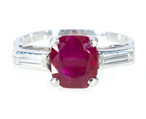 A ruby and diamond three stone ring, a cushion shaped ruby, 7.8mm x 6.5mm, four claw set with a baguette cut diamond to each 