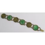 Chinese yellow metal bracelet set with jade discs approx. 2cm dia. with carved design and piercing &