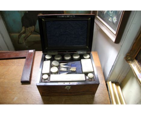 A Victorian walnut vanity travelling case, by Parkins & Gotto, 24/25 Oxford Street, London, containing various silver contain