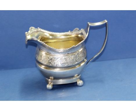 A George III silver milk jug, by T W, London 1813, 209g.