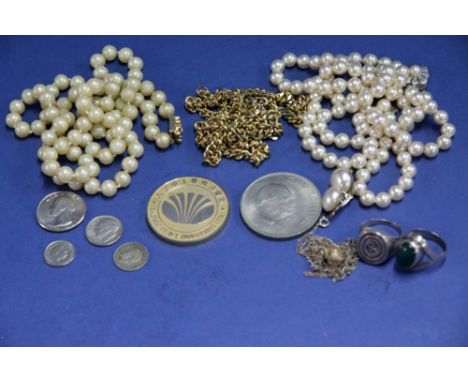 A small bag of pearl necklaces and silver rings.