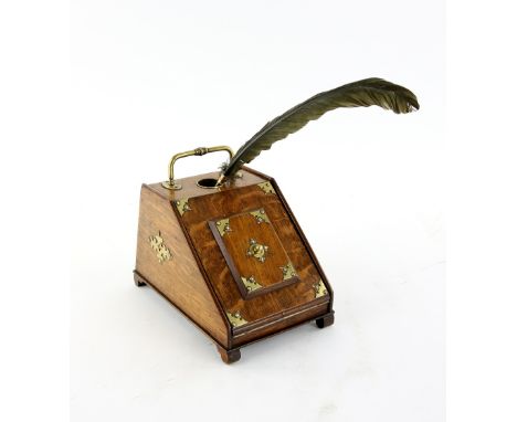 An unusual stationary cabinet inkwell in the form of a purdonium, the lifting lid revealing shelves and drawers, oak with bra