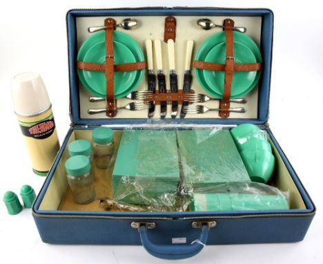 A mid 20th C picnic set with jade green Bestolite tea ware and enamelled tins, and thermos flask, in original packing and  ho