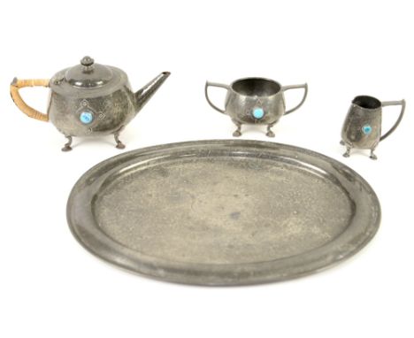 An English pewter tea service with planished finish and Ruskin roundels, with matching tray, marked Gladwin Sheffield , teapo