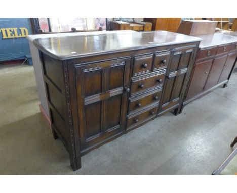 An Ercol dark elm sideboard 
