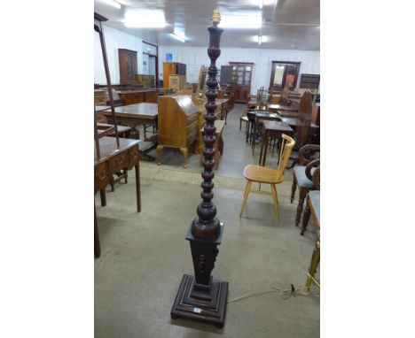An early 20th Century carved oak floor standing lamp 