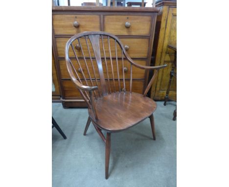 An Ercol elm and beech cow horn armchair 