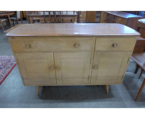 An Ercol Blonde elm and beech Windsor sideboard 