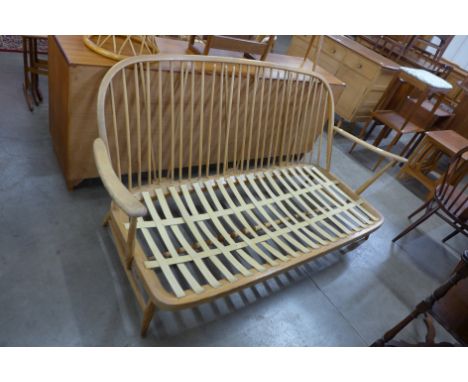 An Ercol Blonde beech Windsor settee, a/f 