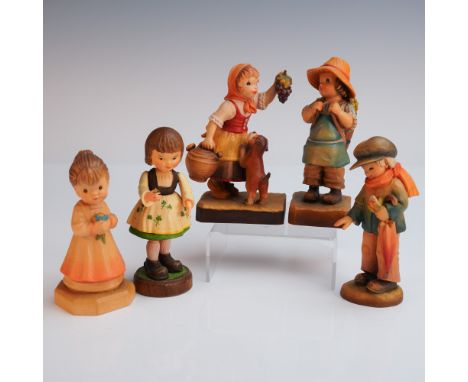 A cheerful group of five hand carved and painted Anri figurines capturing everyday moments with warmth and charm. Included ar