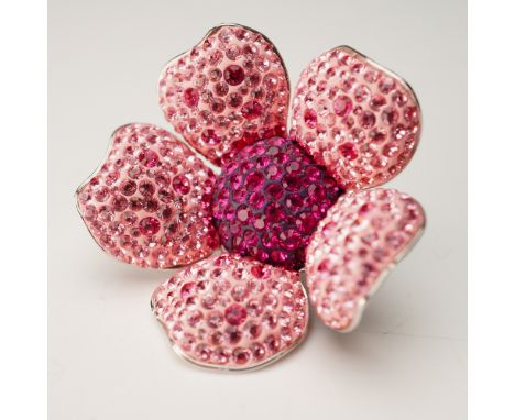 This radiant Swarovski crystal figurine depicts a stylized five-petal blossom, lavishly encrusted with faceted crystals in so