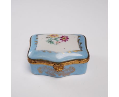 Elegant Limoges porcelain trinket box featuring a rectangular shape with scalloped edges, hand-decorated with a soft blue gro