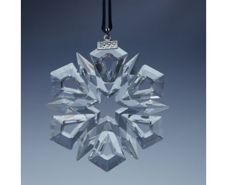 The intricate snowflake design features twelve radiant points, including six kite-shaped extensions, beautifully cut to refle