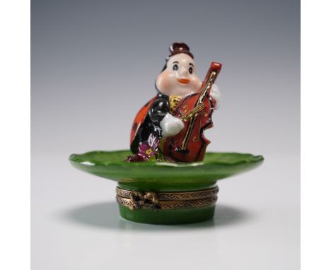 This charming hand-painted Limoges France porcelain figurine features a whimsical ladybug musician playing a cello while seat