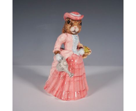 This charming figurine from the Royal Doulton Bunnykins collection, titled May May, features a sweet Bunnykins character dres