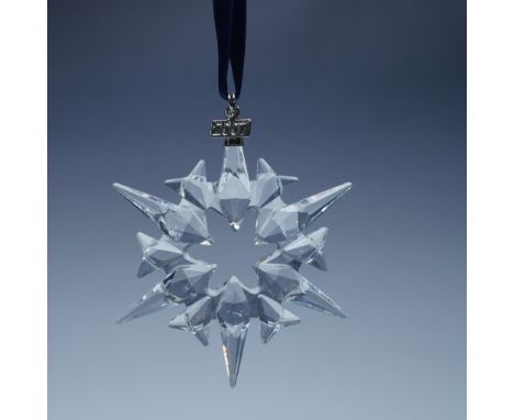 This limited edition Swarovski crystal ornament from 2007 showcases a dazzling twelve-point snowflake design, with six elonga