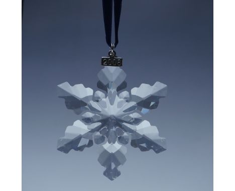 This Swarovski Annual Edition Christmas Ornament from 2008 is a stunning crystal snowflake with intricate faceted details tha
