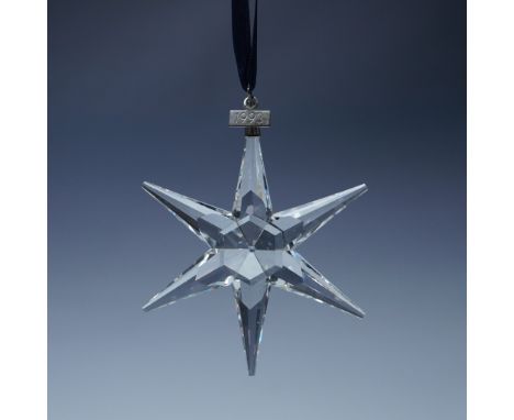 Swarovski crystal holiday ornament from 1993, featuring a stunning multi-faceted star design with six elongated points that c