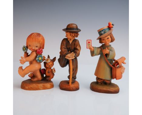 A joyful trio of hand carved and painted Anri figurines, each full of whimsy and charm. Included is a carefree cherub like ch