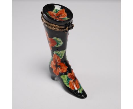 This tall porcelain boot figurine features a striking hand-painted black glaze adorned with vivid orange hibiscus flowers and