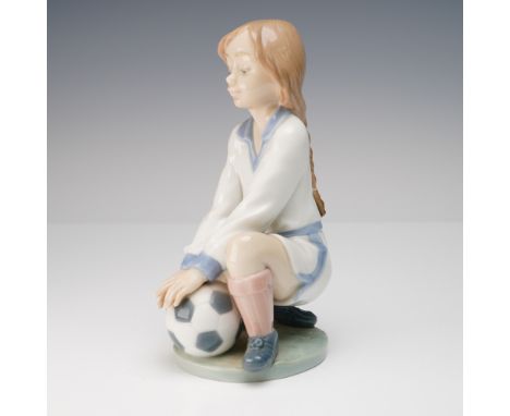 Sporty Lladro porcelain figurine titled Team Player (Spanish name Pose Futbolista), sculpted by Antonio Ramos. Issued in 1994