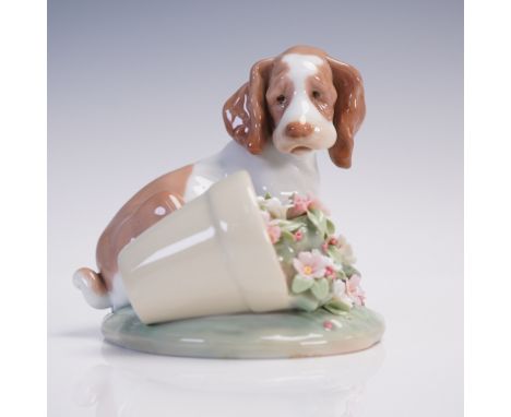 Lladro porcelain figurine titled It Wasn't Me! model number 1007672, depicting a brown and white puppy sitting beside an over