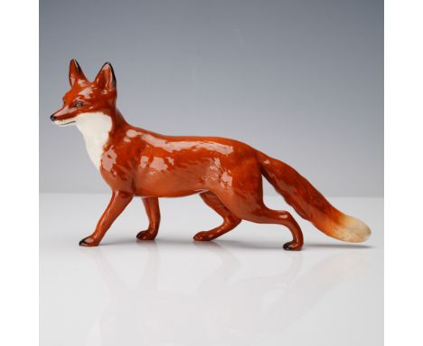 A hand-painted Beswick porcelain figurine depicting a poised red fox in mid-stride. Modeled with lifelike detail, the fox fea