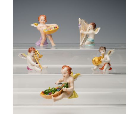 A delightful assemblage of five hand-painted German porcelain cherubs, comprising three music-themed angels by Volkstedt and 
