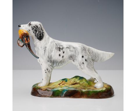 This finely modeled porcelain figurine by Royal Doulton portrays an English Setter proudly holding a pheasant in its mouth, r