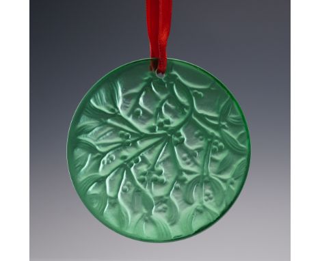This festive Lalique crystal ornament from 1990 features a mistletoe motif in luminous green crystal, beautifully rendered in