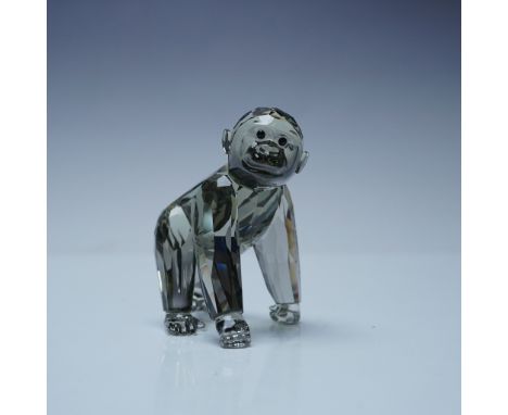 This Swarovski Crystal Society (SCS) figurine features a captivating gorilla cub, crafted from faceted Black Diamond crystal,