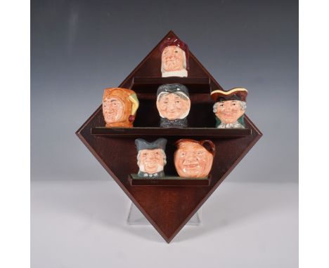 A set of six Royal Doulton miniature character jugs (1.5"H), each meticulously crafted and hand-painted, representing well-kn