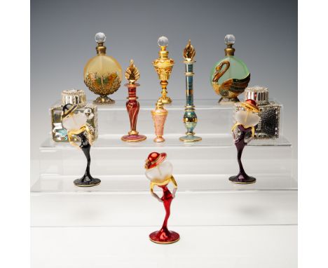 A charming group of eleven decorative scent bottles in a variety of whimsical and ornate designs. This eclectic collection in
