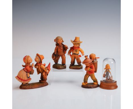 A heartwarming group of five hand carved and painted Anri wooden figurines, each capturing scenes of rural life with signatur