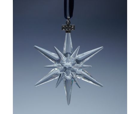 This limited edition Swarovski crystal ornament from 2005 features a dazzling starburst design with twelve precisely cut poin