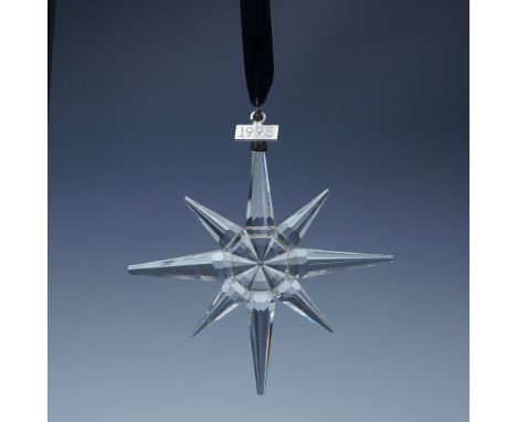 Swarovski crystal holiday ornament from 1995, featuring an elegant eight-pointed star design with expertly cut facets that be