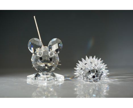 Two Swarovski crystal figurines designed by Max Schreck. The first, 'Mouse King', features a clear crystal body with black ey