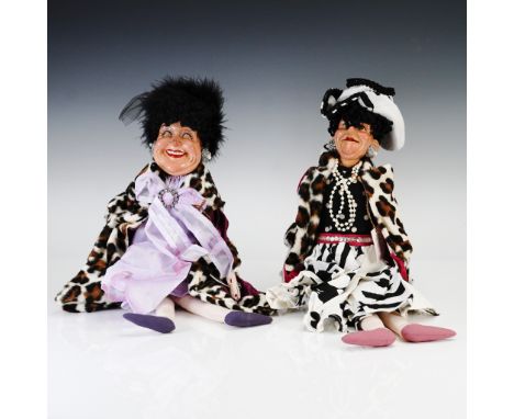 This delightful 2-piece set from Katherine's Collection features seated lady dolls dressed in bold, theatrical attire with fa