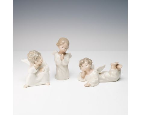 A set of three Lladro porcelain figurines depicting charming child angels in various poses, each sculpted by Fulgencio Garcia