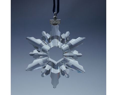 This retired limited edition Swarovski Christmas ornament was issued by D. Swarovski. Featuring a stunning twelve-pointed sno
