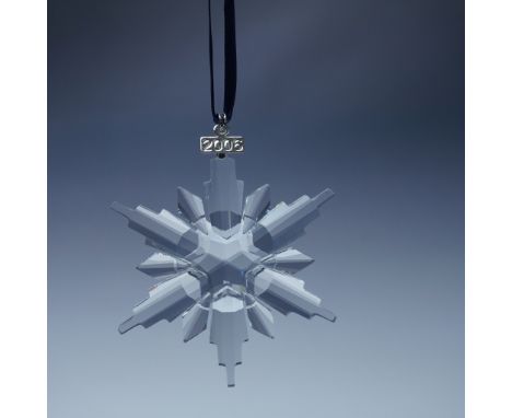 This limited edition Swarovski crystal ornament from 2006 features a stunning twelve-point snowflake design, with six elongat