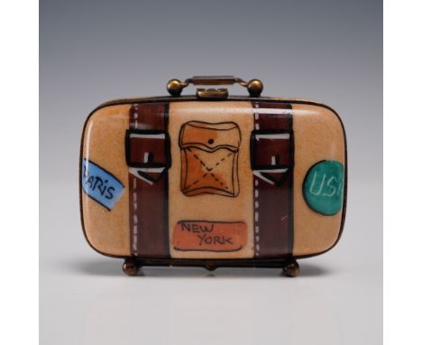 Hand-painted Limoges porcelain trinket box in the form of a vintage suitcase with painted travel labels for Paris, New York, 