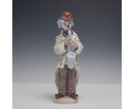Depicts a clown musician with a downcast expression, standing as he plays a white saxophone. He wears a brown hat, oversized 